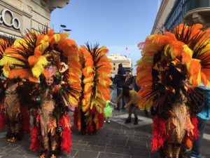 dancers in giant flowered headdresses, and not much else