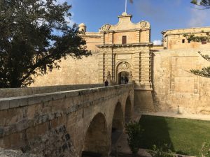 Stone bridge over the dry moat and walls of the city of Mdina